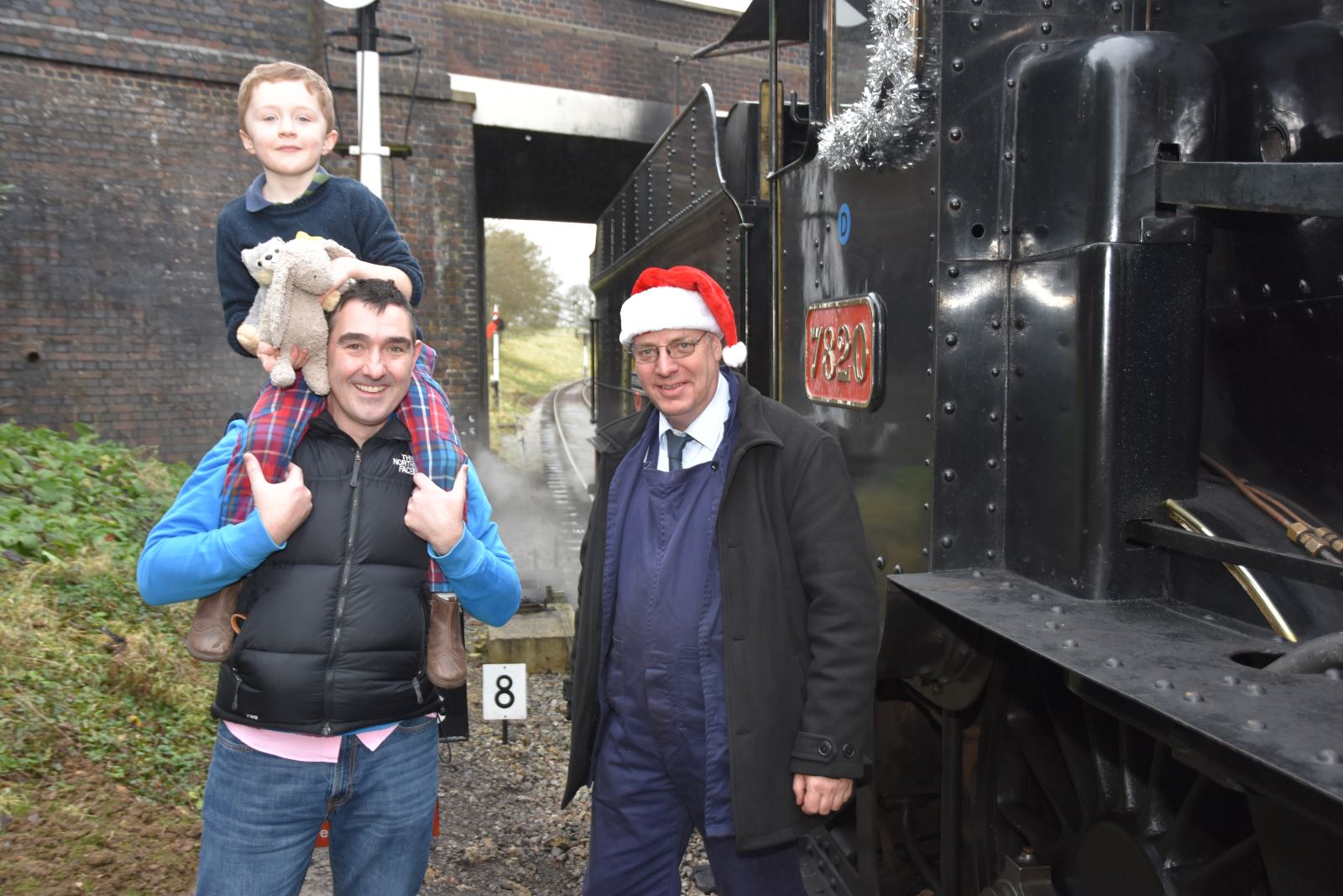 Festive driver Paul with guests at GWSR